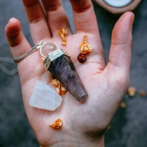 black pendant on palm