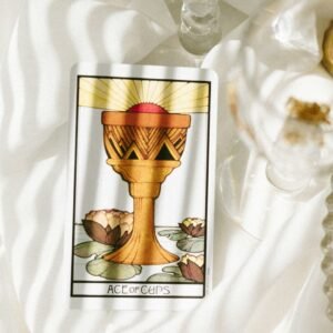 a tarot card sitting on top of a white cloth